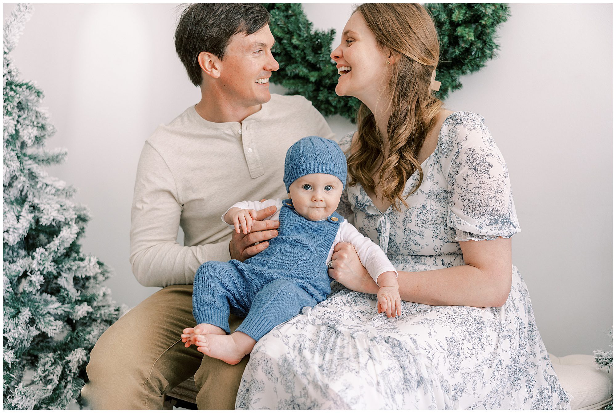 christmas photos with mom, dad and baby in a blue bonnet
