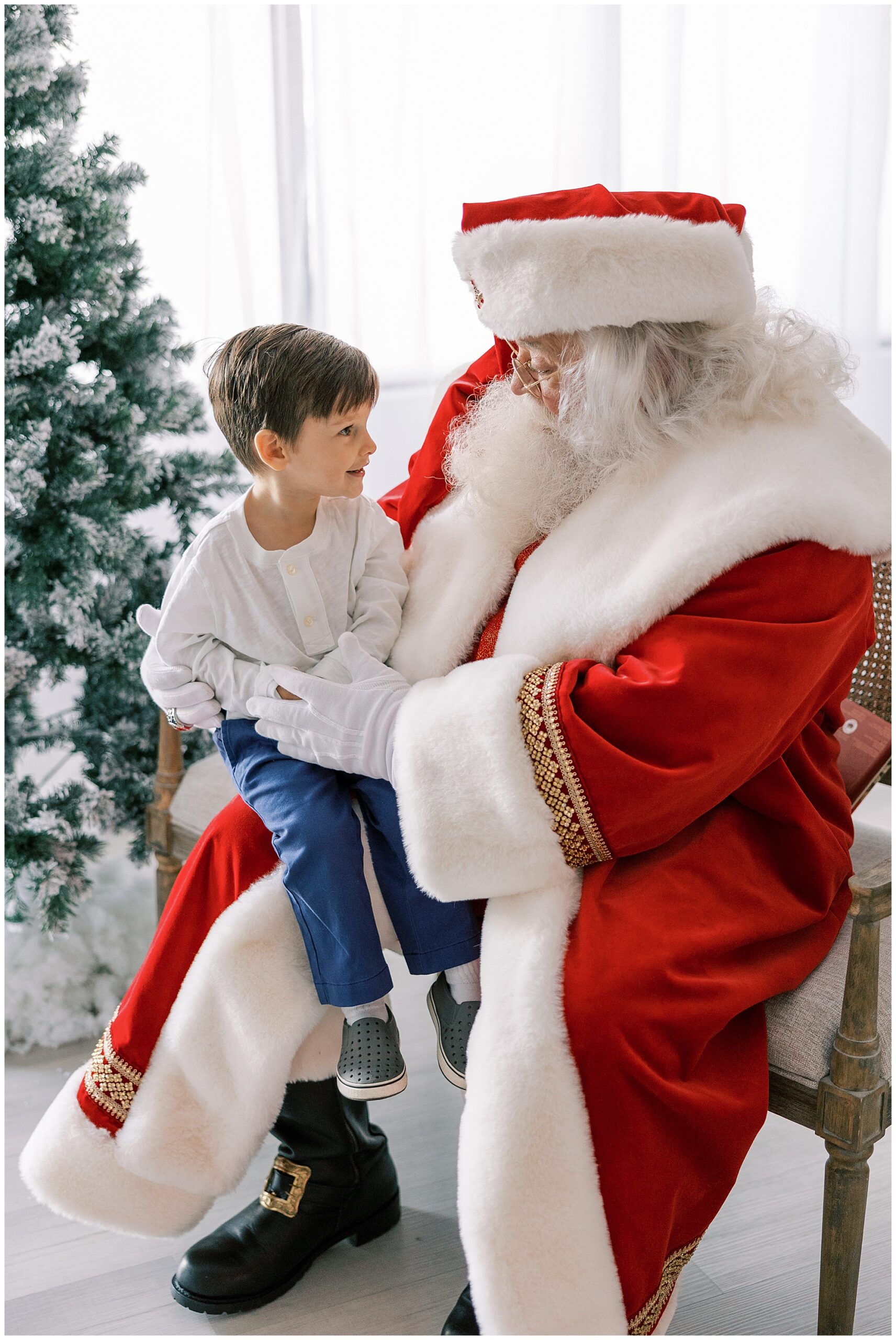 boy sitting on Santa's lap at Knoxville Santa sessions