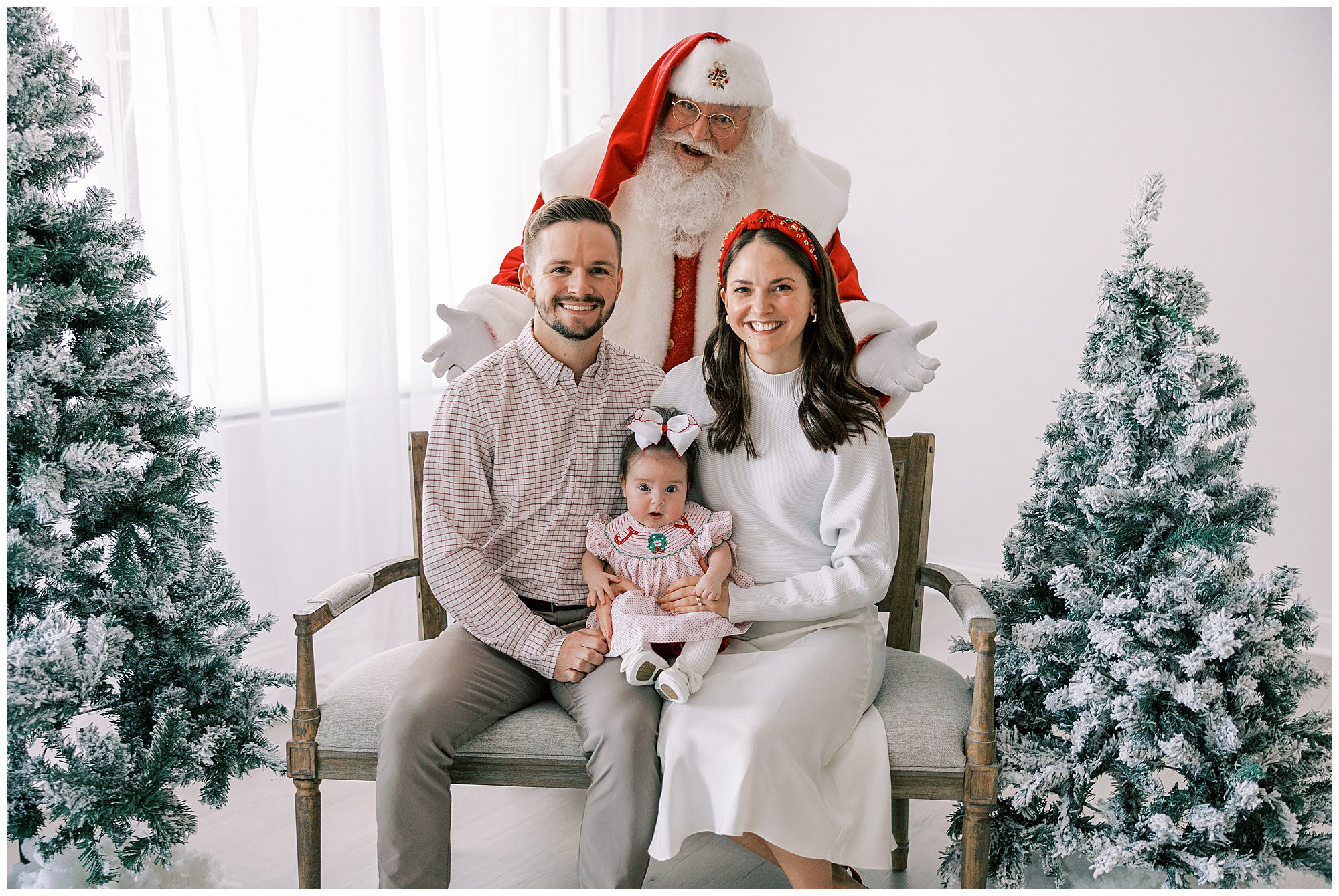 mom dad and baby with santa