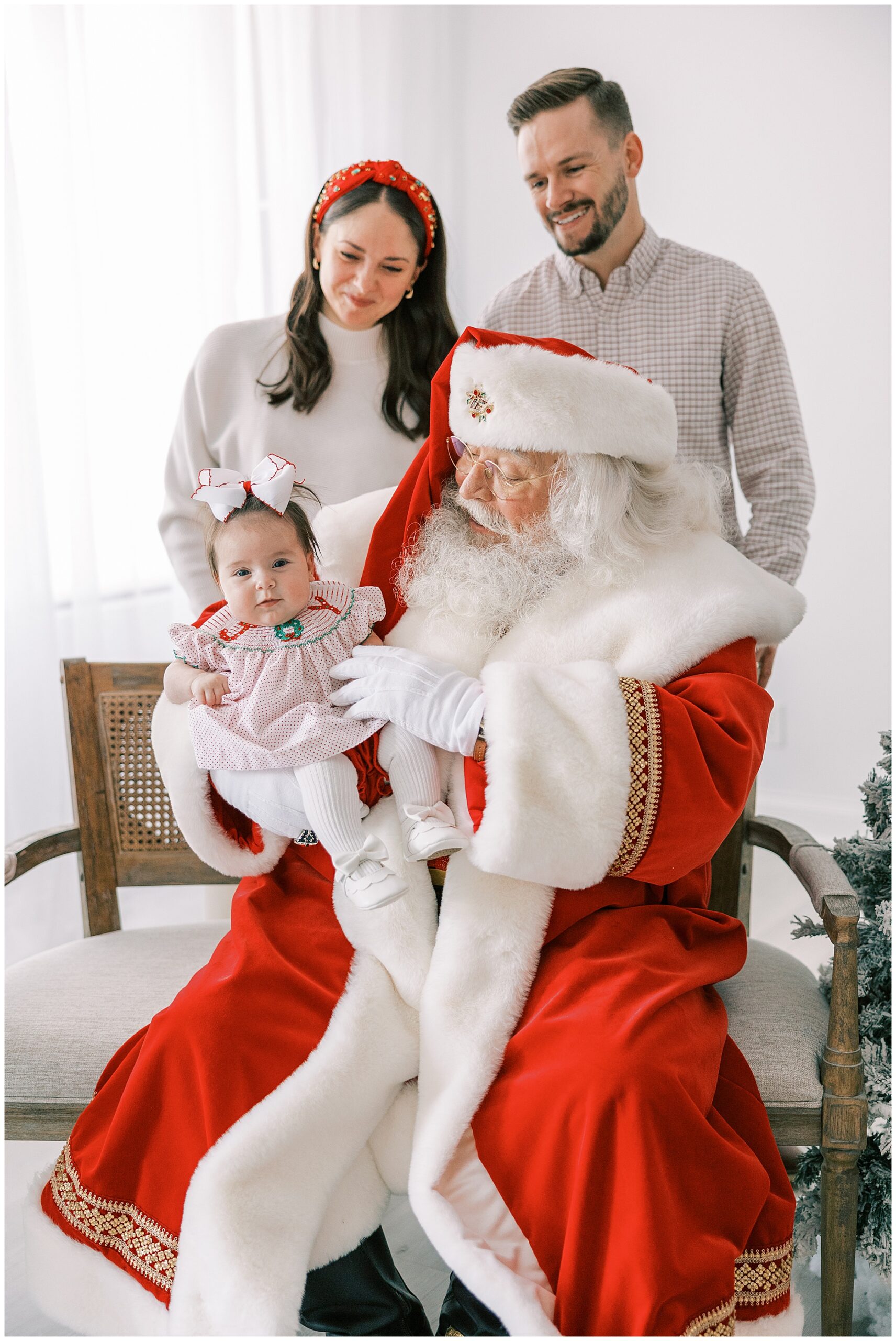 mom dad and baby with Santa
