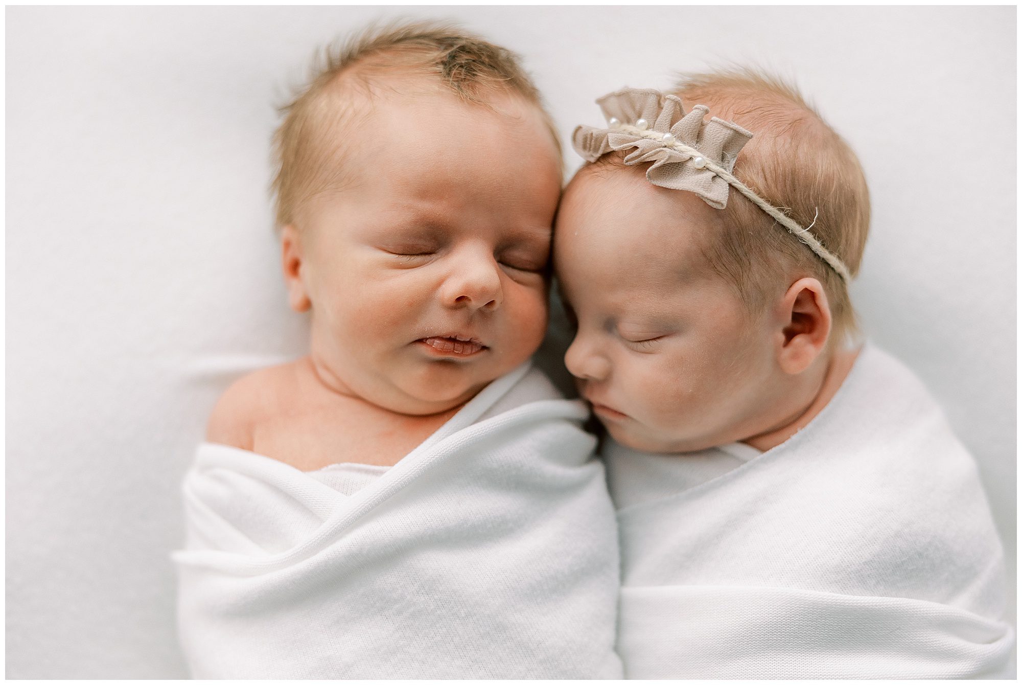 baby twins laying beside each other