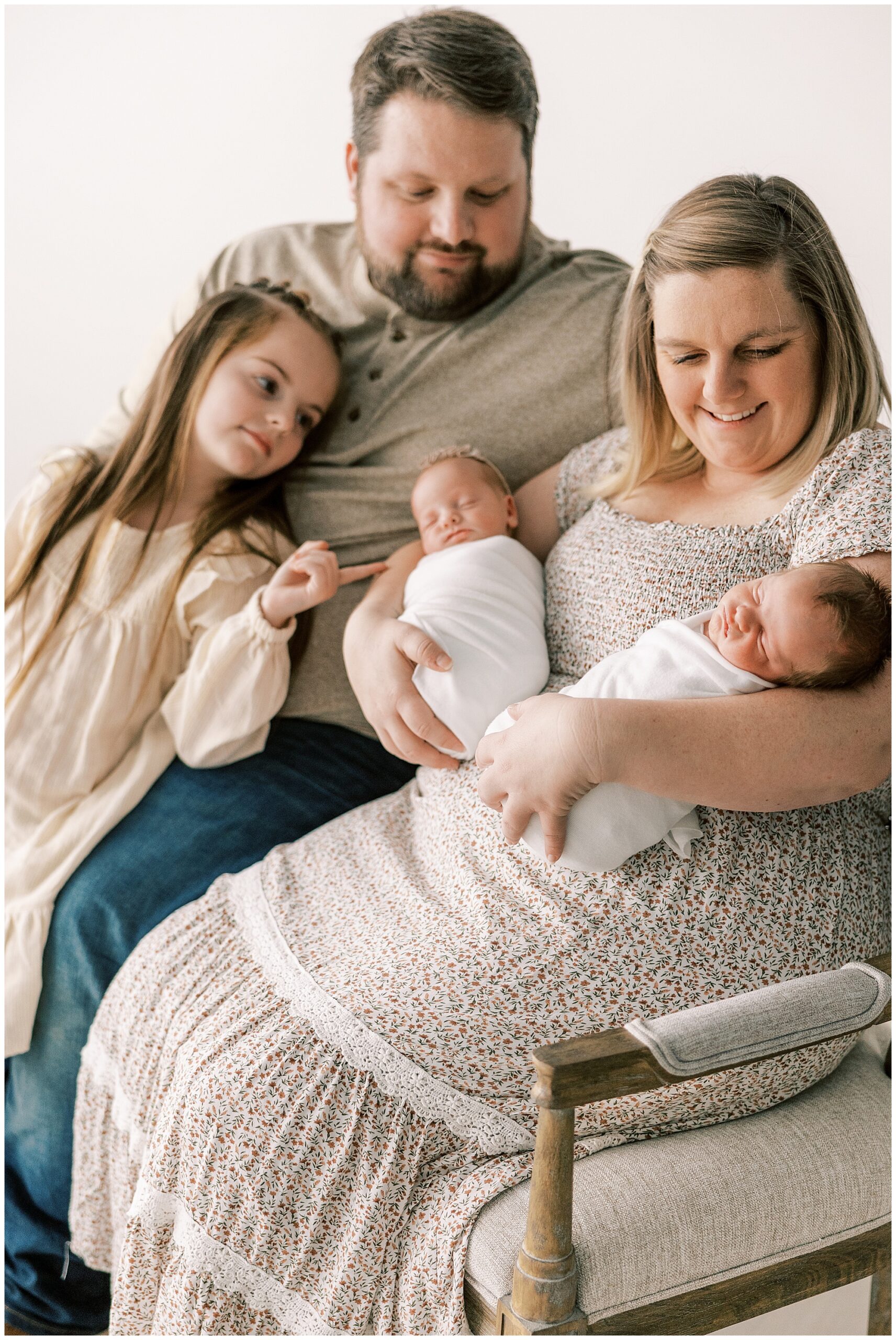 whole family sitting on a bench at newborn session