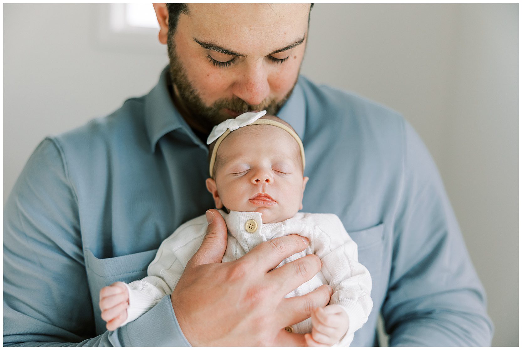 baby girl snuggling on dad's chest