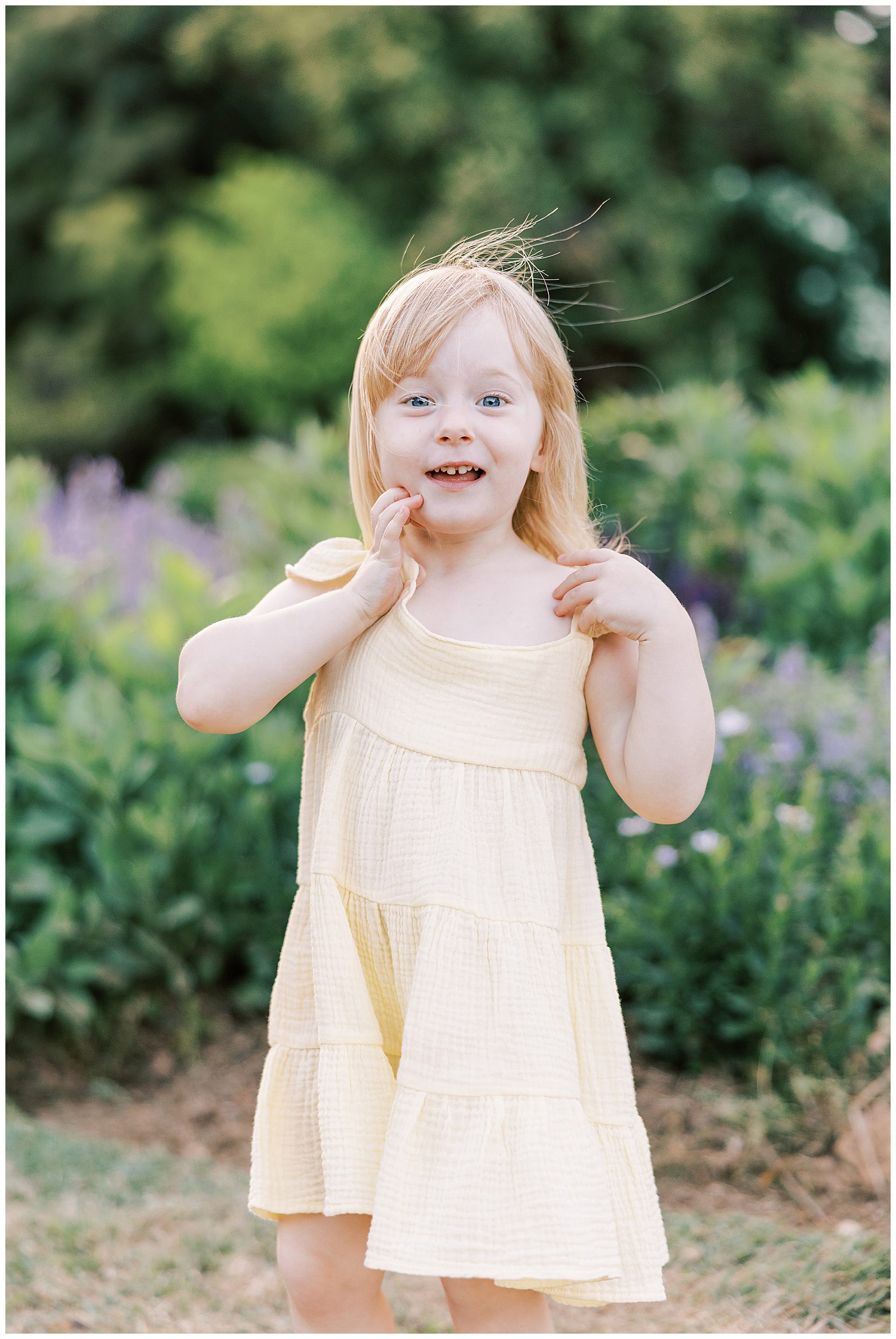 little girl smiling in a field of flowers