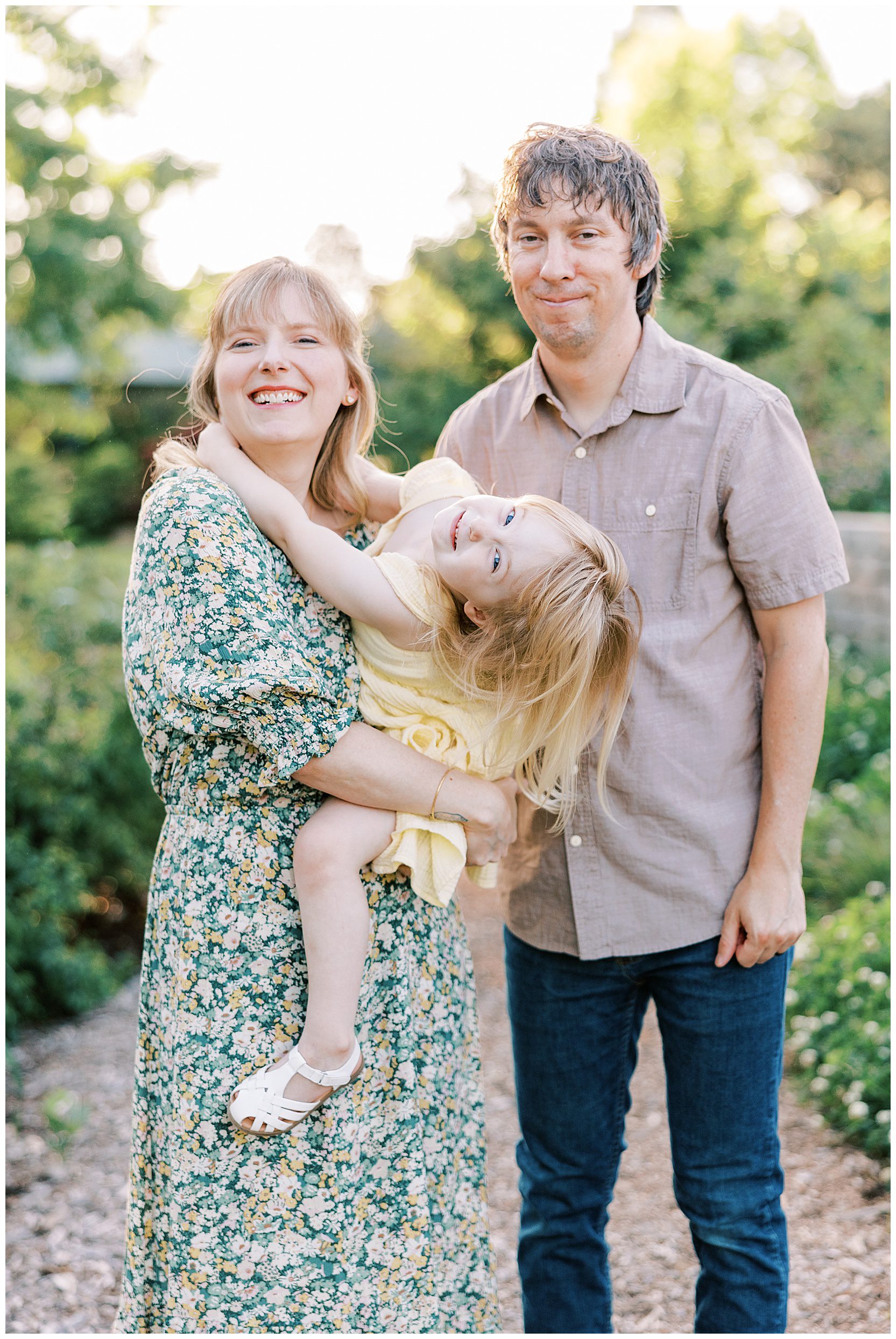 family smiling at camera at ut gardens