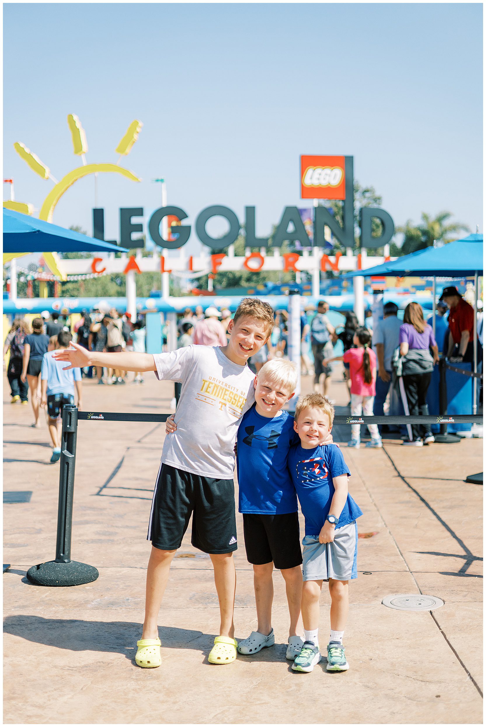 boys posing in front of legoland