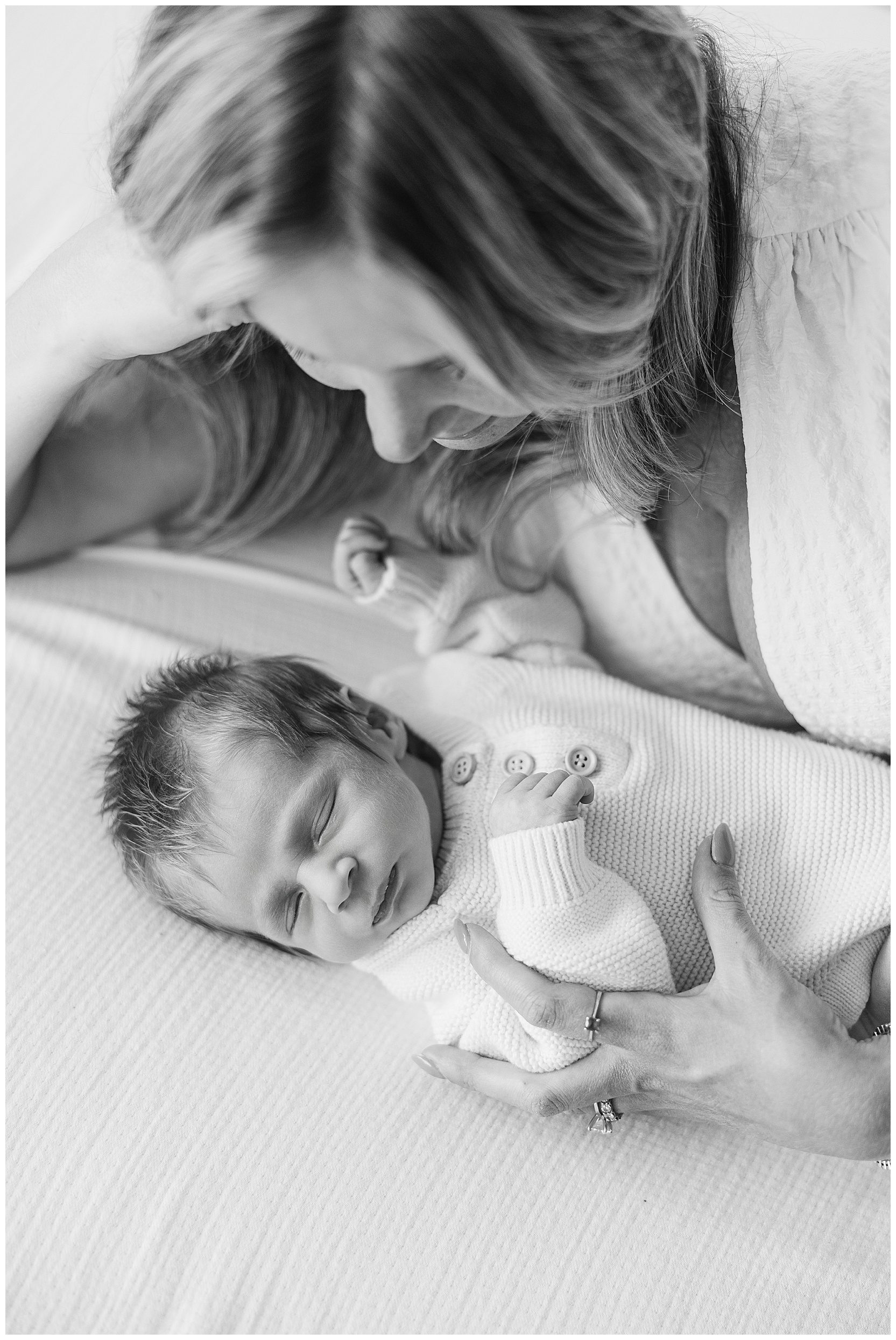 mom laying beside sleeping baby