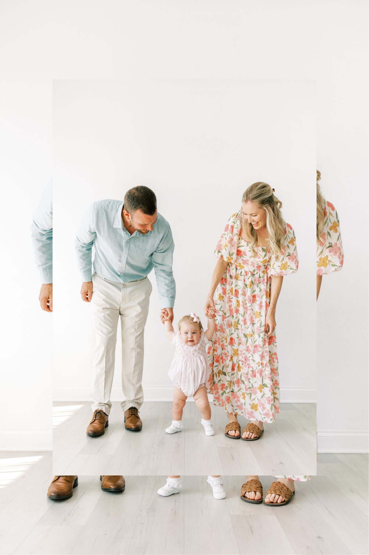 family together, holding baby hand