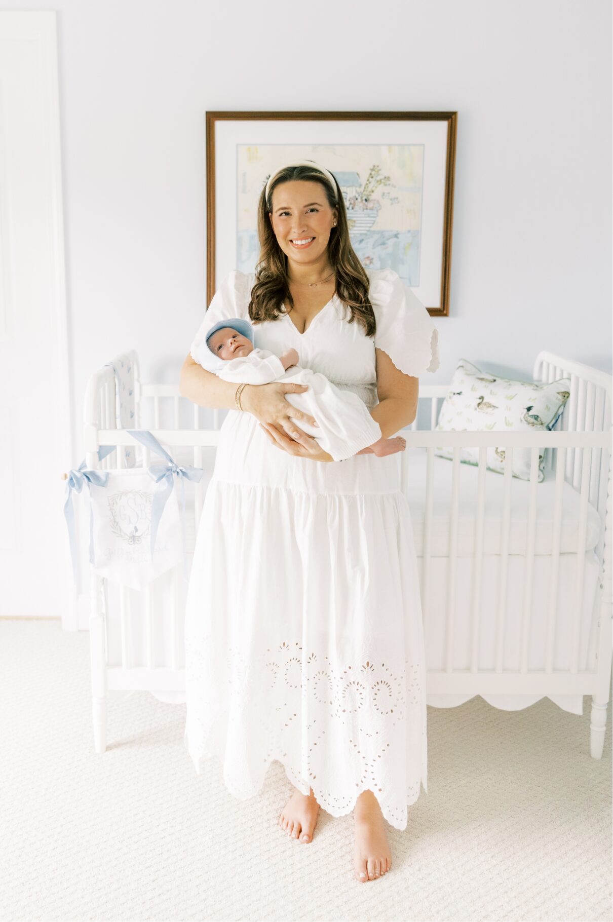 mom holding baby smiling at camera