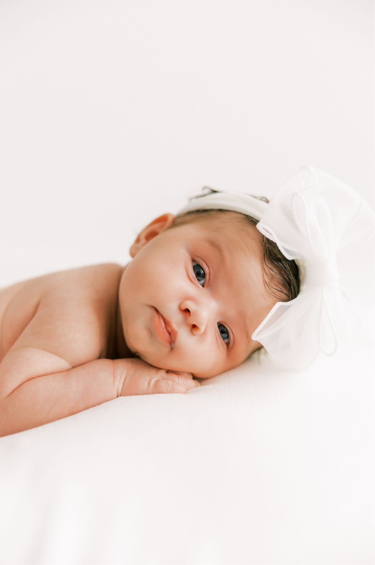 baby girl with white bow
