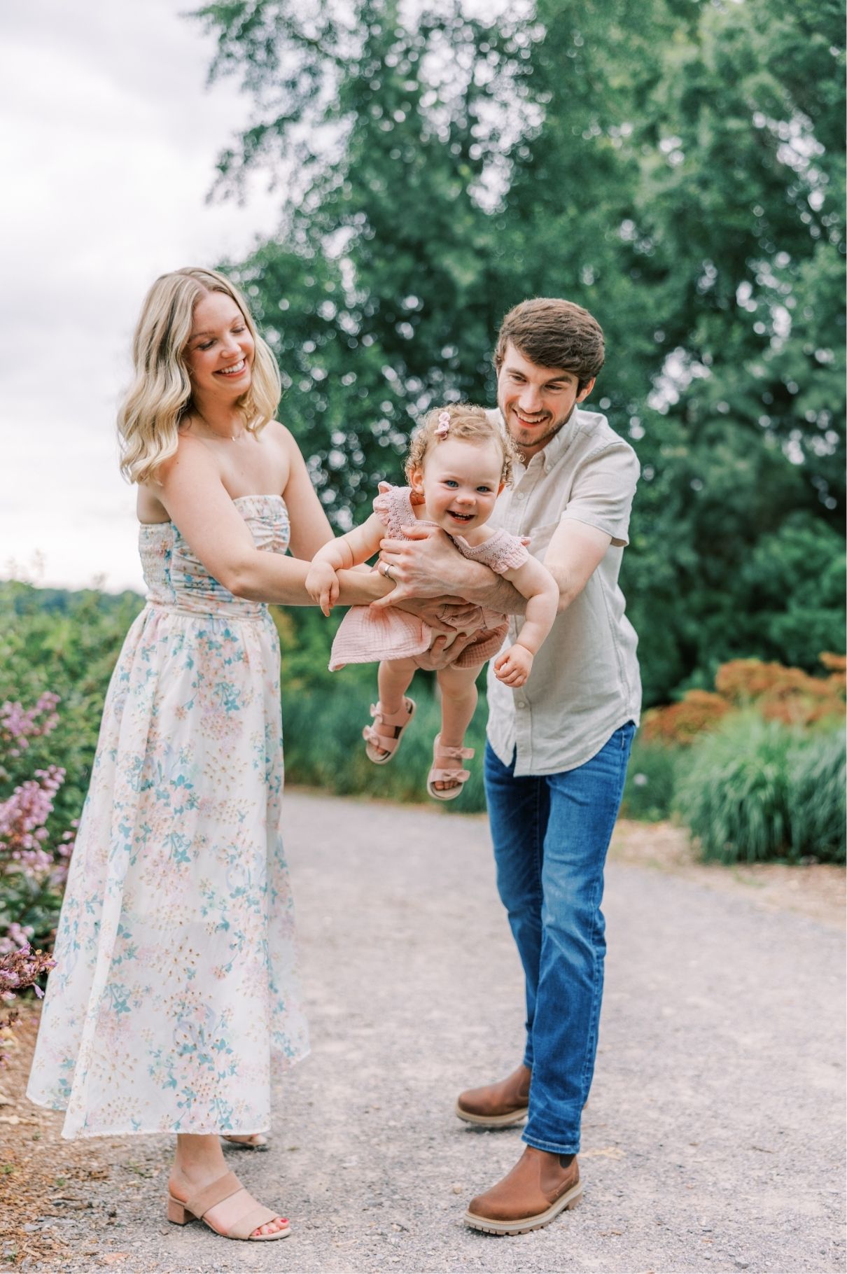Mom and dad rocking baby laughing