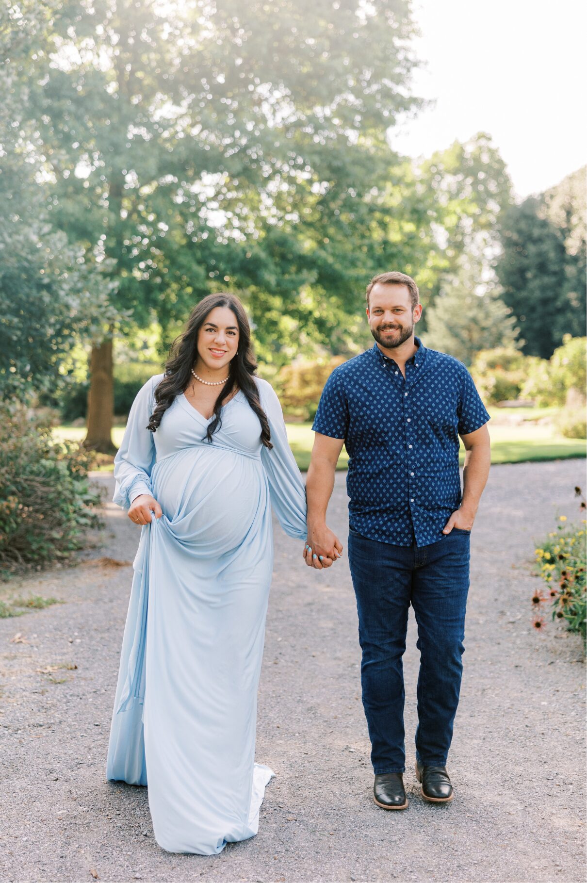 walking holding hands looking at the camera