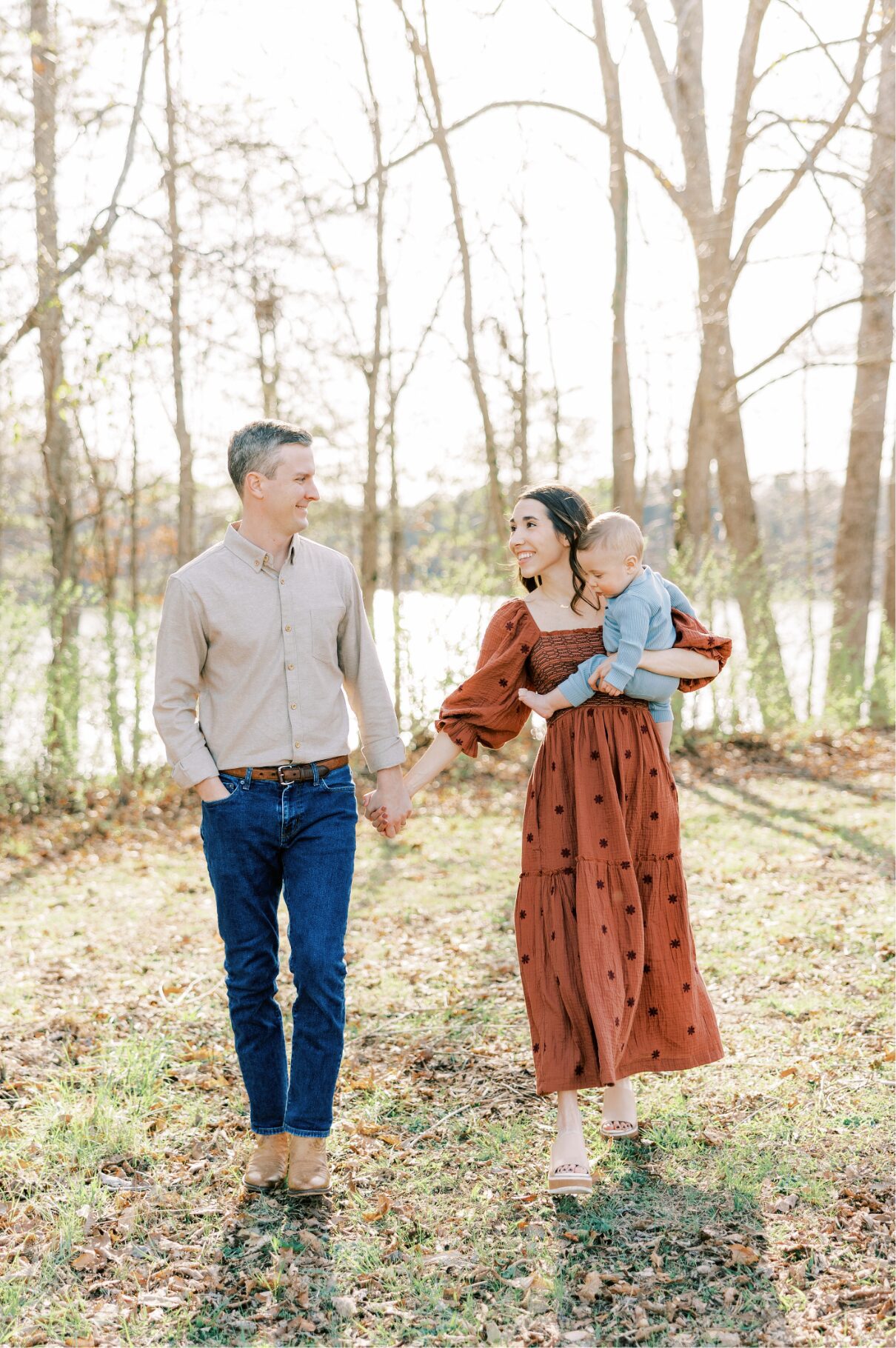family walking holding hands looking at each other