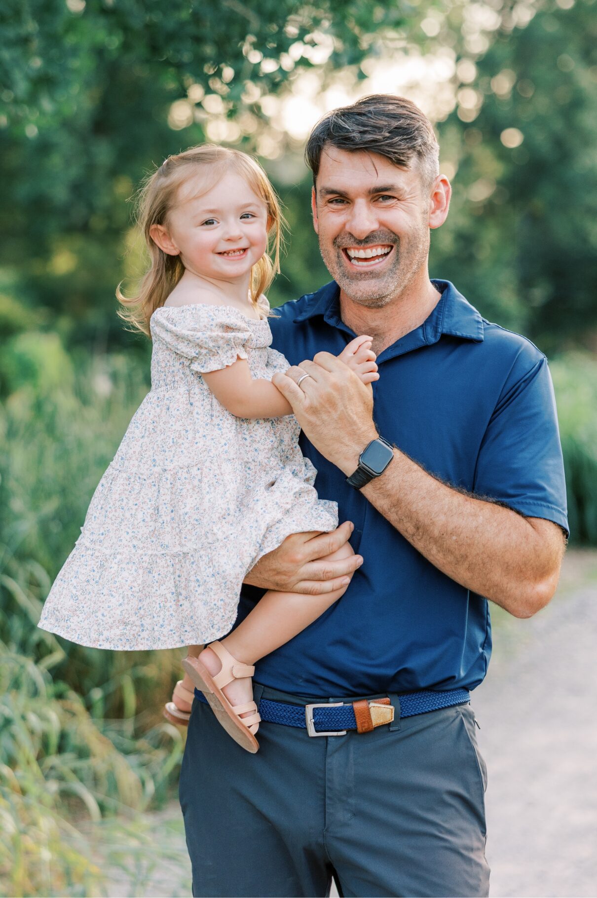 dad and little girl smiling at camera