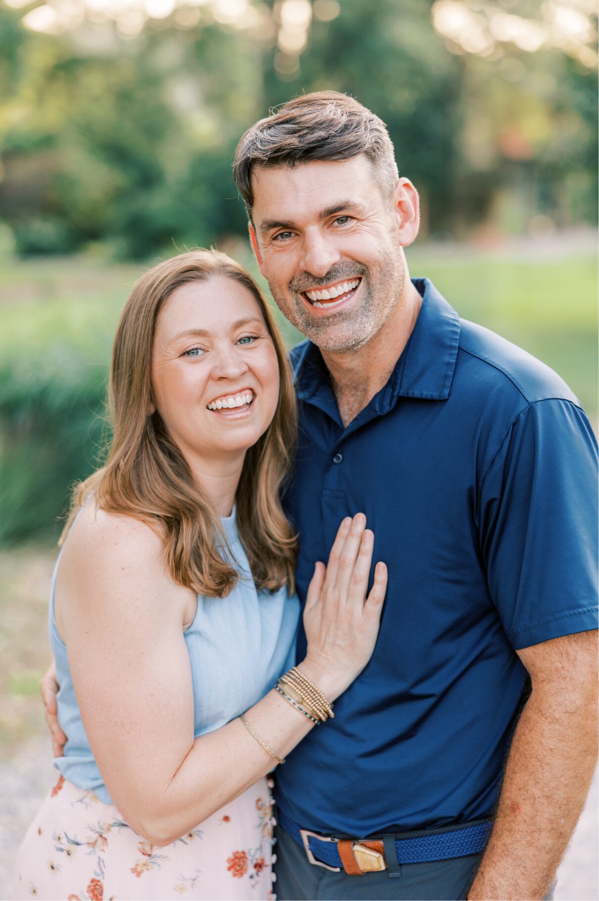mom and dad smiling at camera