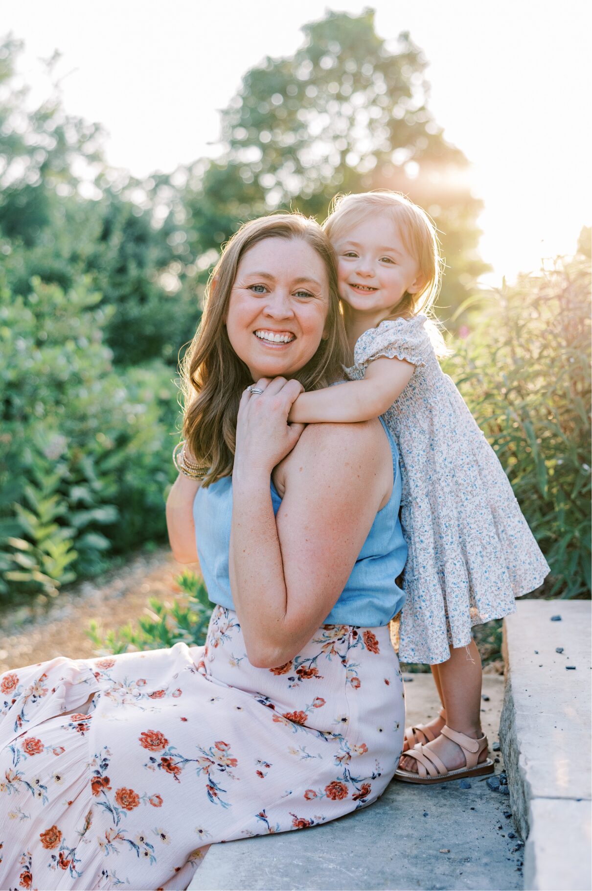 mom and little girl smiling at camera