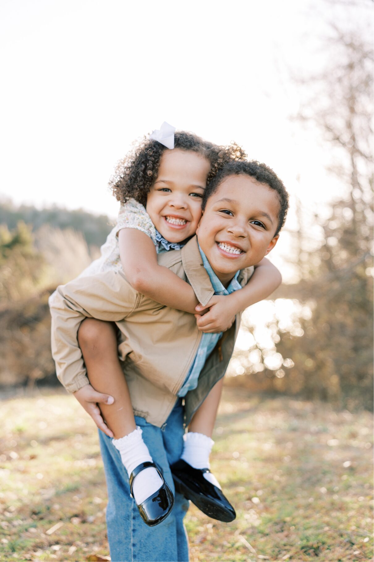 girl on brothers back smiling