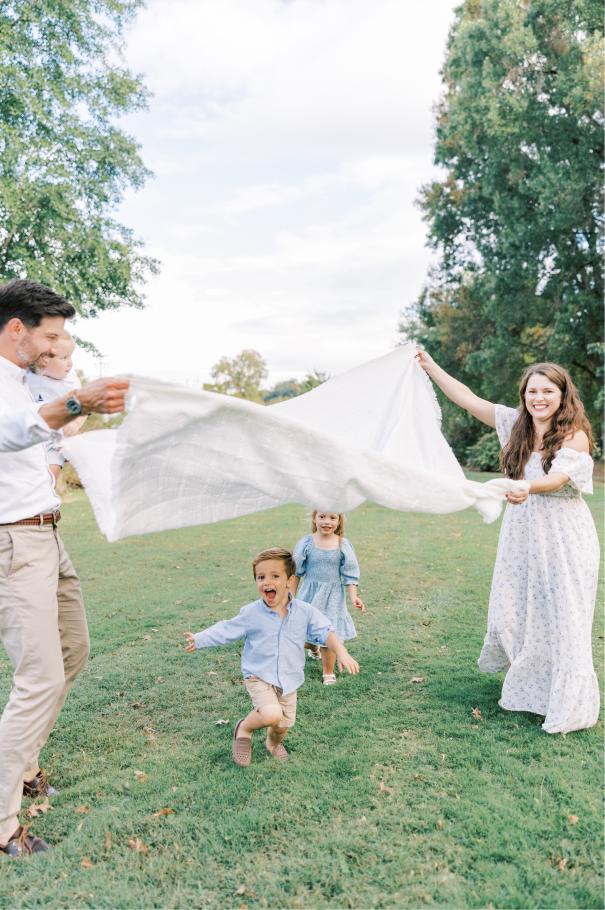 kids running under blanket